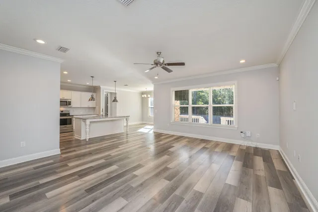 a view of a kitchen with wooden floor and a kitchen