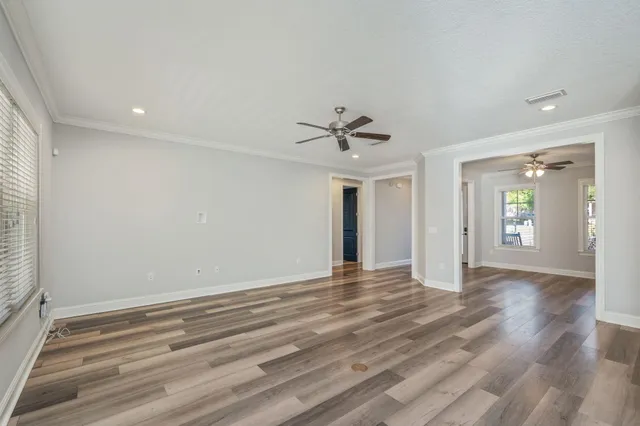 wooden floor in an empty room with a window