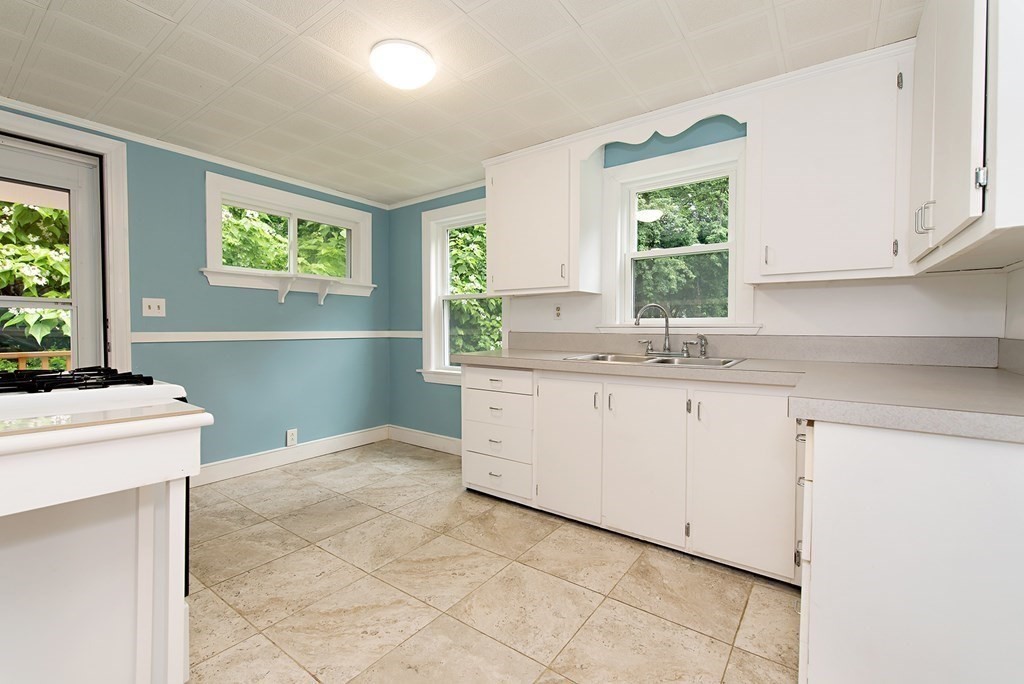 44 Charlotte Road Walpole, MA 02032 - Photo 4 of 25 a kitchen with a sink cabinets appliances and a window