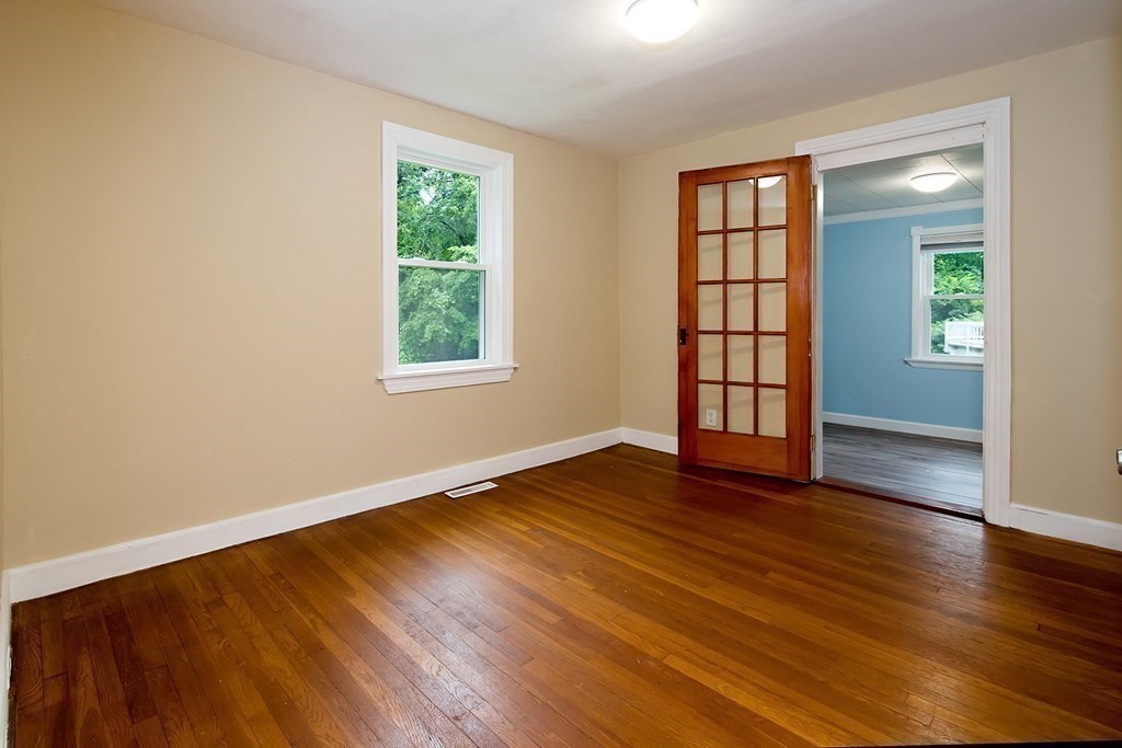 44 Charlotte Road Walpole, MA 02032 - Photo 9 of 25 an empty room with wooden floor and windows