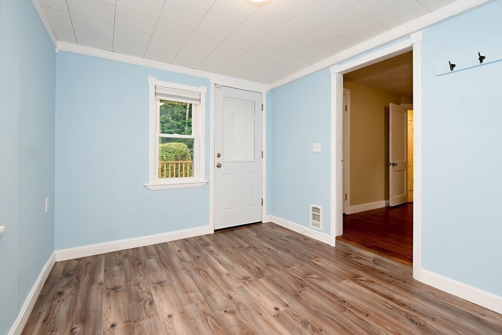 44 Charlotte Road Walpole, MA 02032 - Photo 10 of 25 a view of an empty room with wooden floor and a window