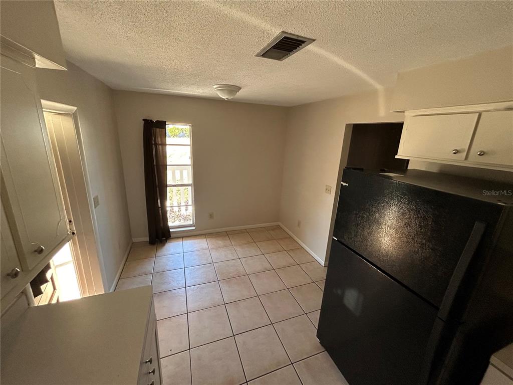 21696 Southwest Raintree Street Dunnellon, FL 34431 - Photo 12 of 35 a view of an empty room with window and wooden floor