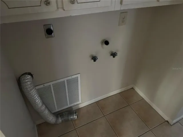 a view of a room with rack and wooden cabinets