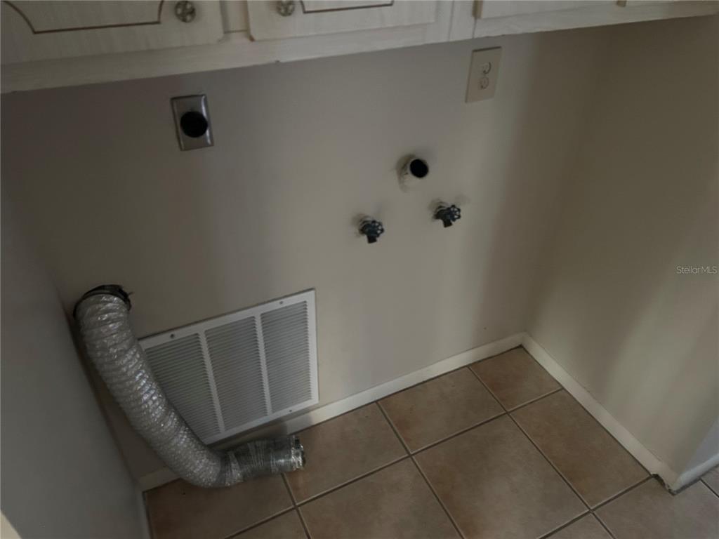 21696 Southwest Raintree Street Dunnellon, FL 34431 - Photo 26 of 35 a view of a room with rack and wooden cabinets