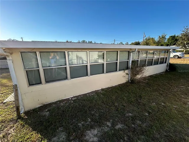 a view of a house with a yard and sitting area