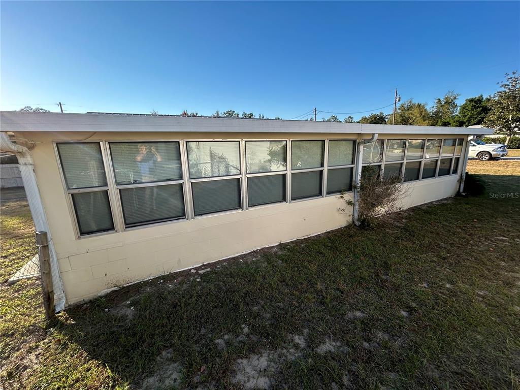 21696 Southwest Raintree Street Dunnellon, FL 34431 - Photo 6 of 35 a view of a house with a yard and sitting area
