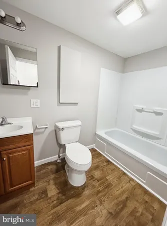 a bathroom with a toilet a sink and bathtub