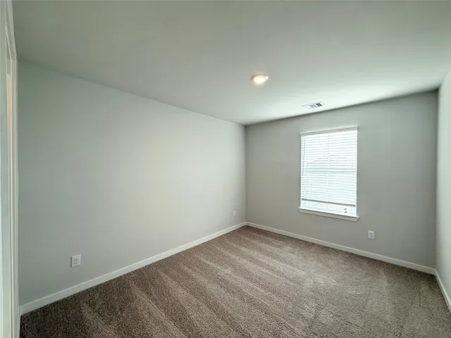 an empty room with a empty space and windows