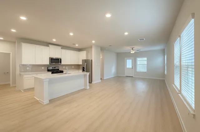 a kitchen with a sink a stove and cabinets