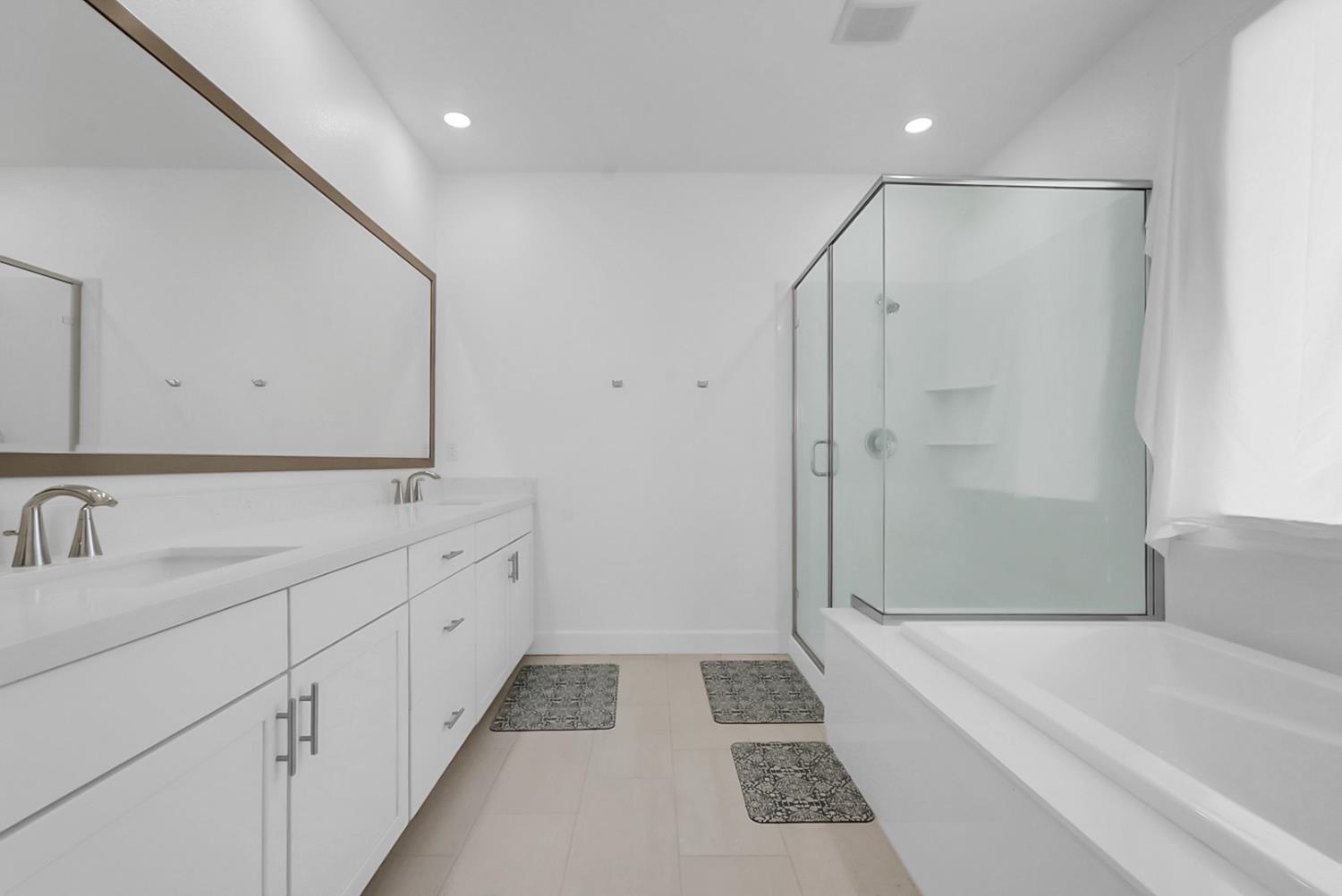 6705 Fathom Road Stockton, CA 95219 - Photo 13 of 19 a bathroom with a tub sink shower and mirror