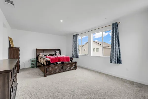 a bedroom with a bed and window