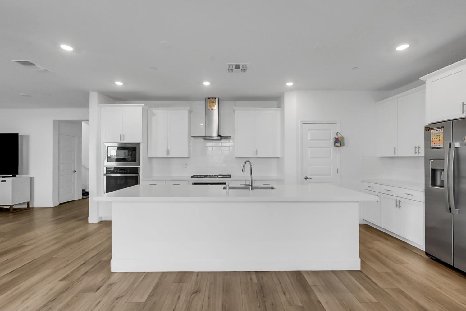 6705 Fathom Road Stockton, CA 95219 - Photo 7 of 19 a large white kitchen with a large counter top appliances and cabinets