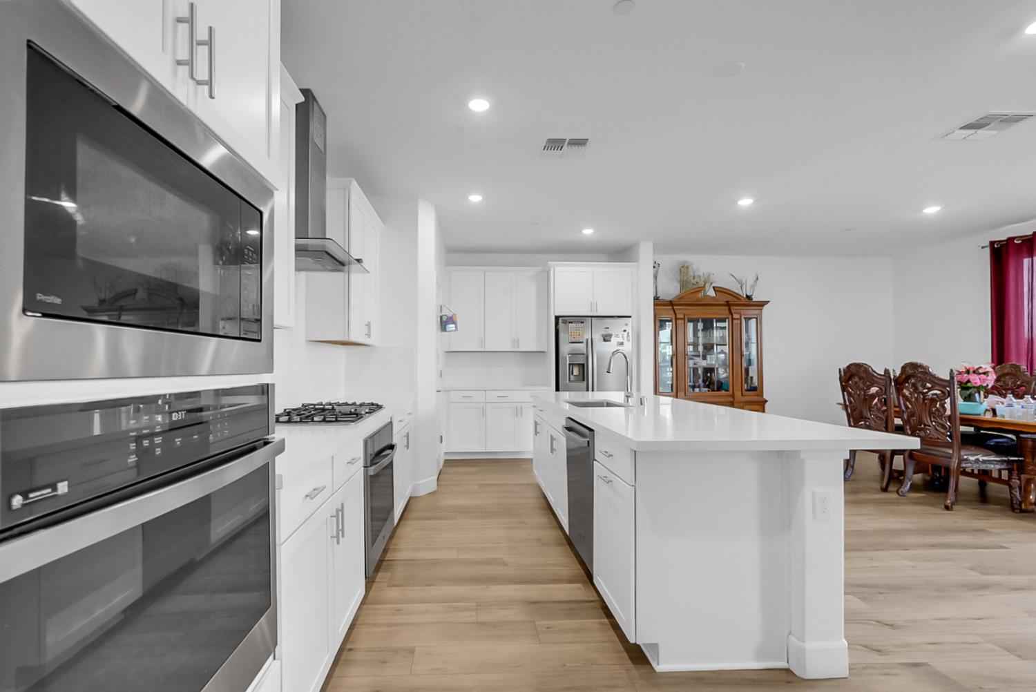 6705 Fathom Road Stockton, CA 95219 - Photo 8 of 19 a kitchen with stainless steel appliances a stove top oven a sink a refrigerator and white cabinets