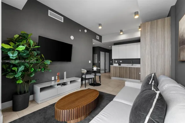 a living room with furniture and a flat screen tv