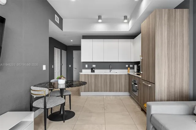 a kitchen with a cabinets and chairs