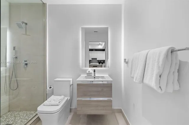 a bathroom with a sink toilet and shower