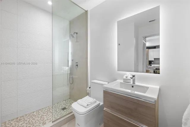 a bathroom with a sink toilet and shower