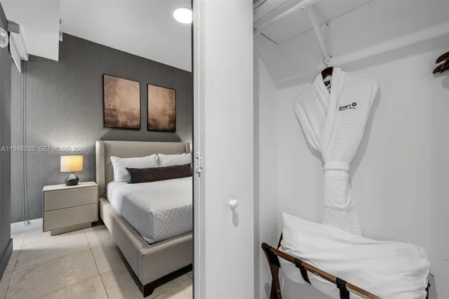 a bedroom with a bed and a chair