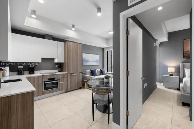 a kitchen with a refrigerator and a stove top oven