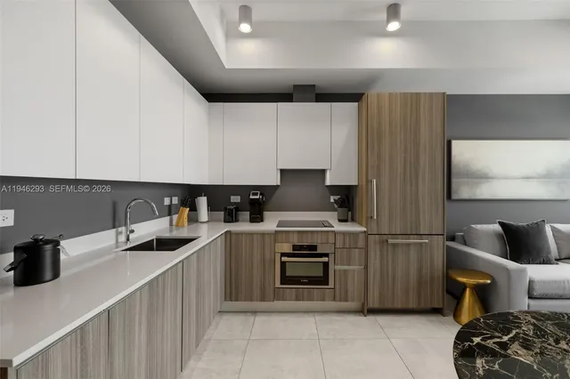 a kitchen with stainless steel appliances a sink and a refrigerator
