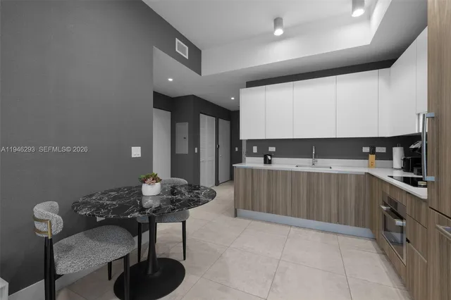 a kitchen with stainless steel appliances kitchen island granite countertop a sink and cabinets