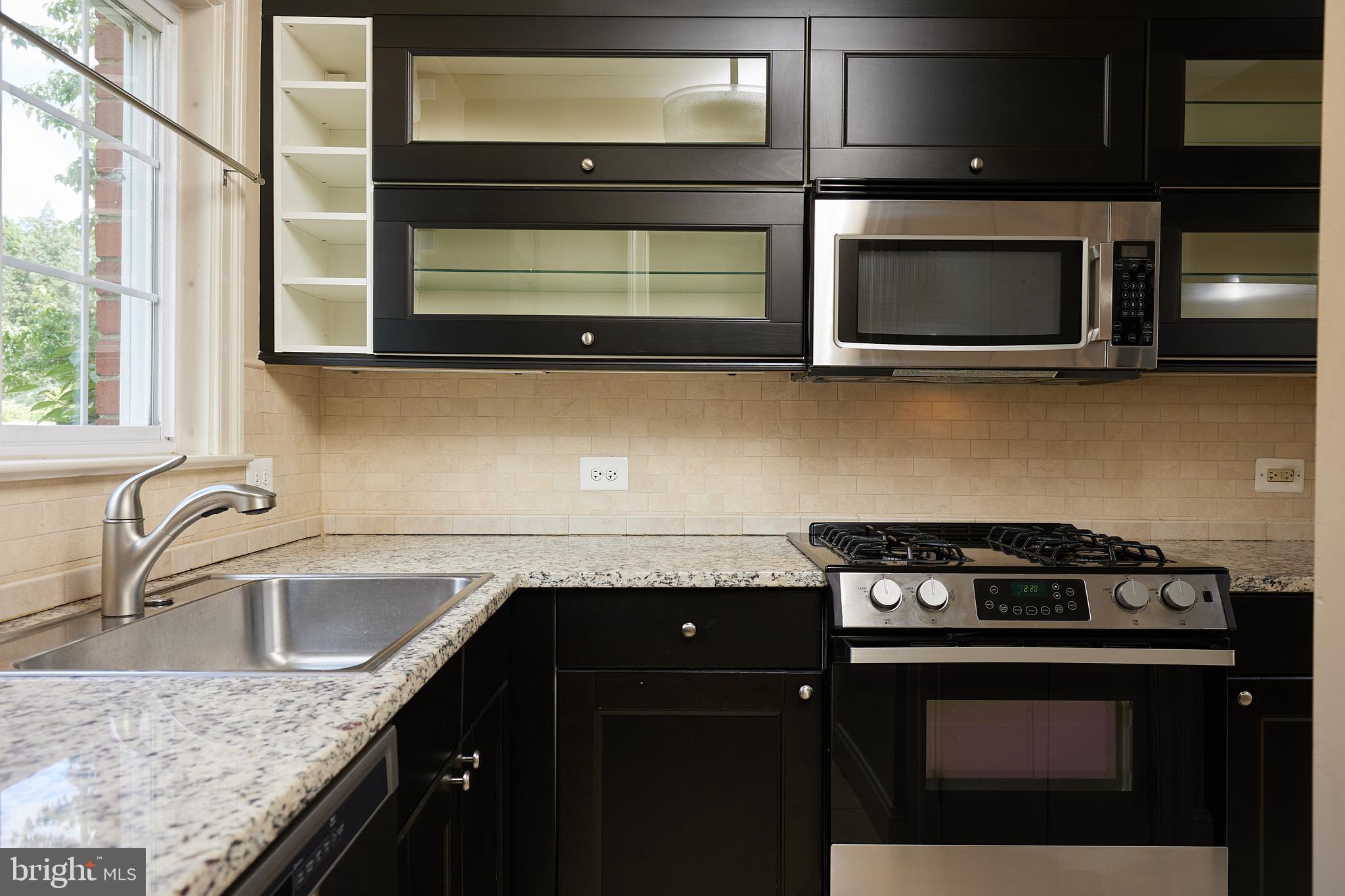 3324 Gunston Road Alexandria, VA 22302 - Photo 8 of 10 a kitchen with granite countertop a stove microwave and sink