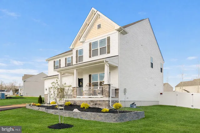 a view of a hallway with wooden floor and stairs