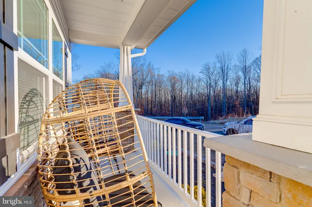 a kitchen with stainless steel appliances a sink a stove a refrigerator and white cabinets with wooden floor