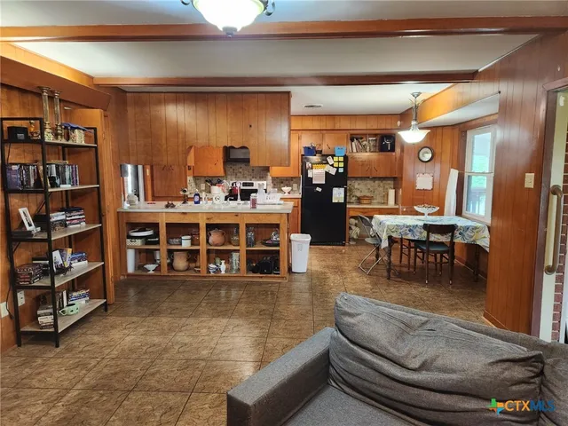 a living room with furniture and a book shelf