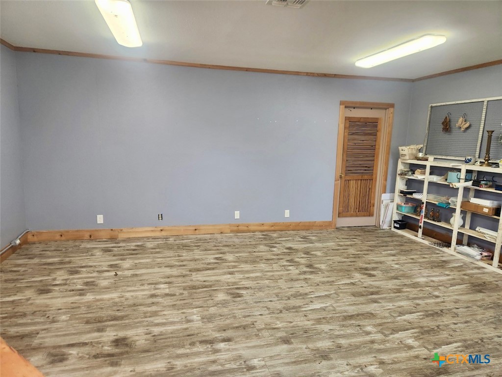 306 Dover Street Victoria, TX 77905 - Photo 5 of 23 a view of an empty room with wooden floor and windows