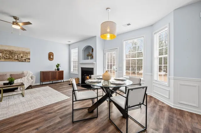 a living room with furniture a fireplace and a table