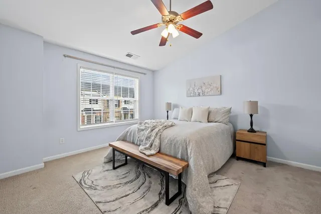 a bedroom with a bed and a window