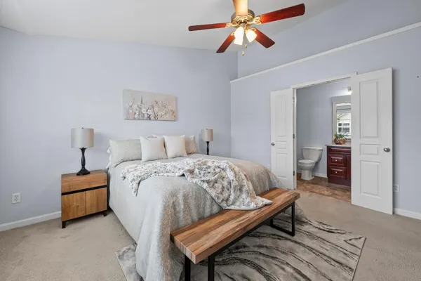 a bedroom with a bed and a chandelier