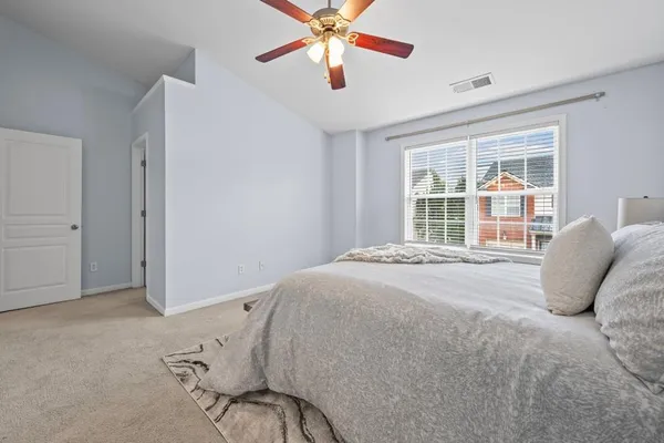 a bed room with a bed and a large window
