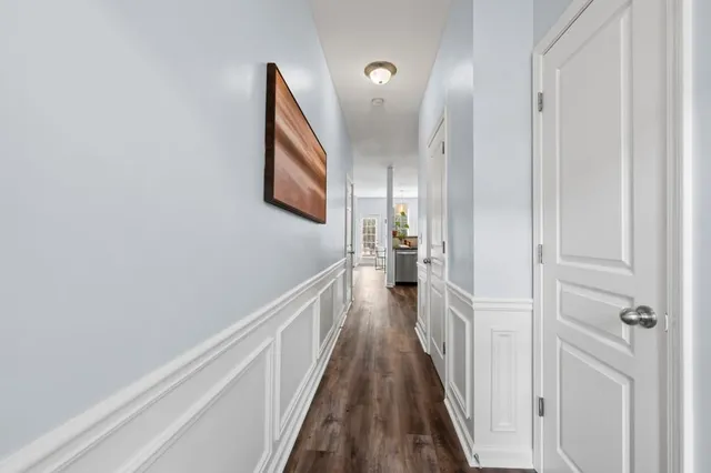 a view of a hallway with wooden floor and staircase