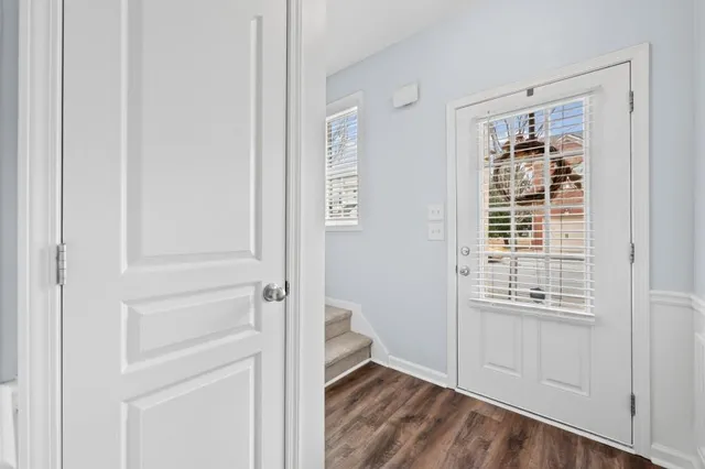 a view of an entryway with wooden floor