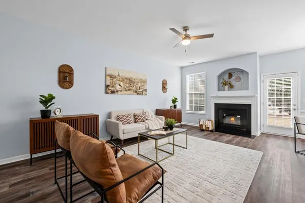 a living room with furniture and a fireplace