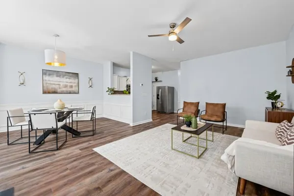 a living room with furniture and wooden floor