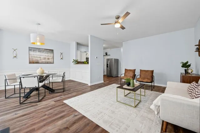 a living room with furniture and wooden floor