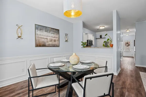 a view of a dining room with furniture and wooden floor