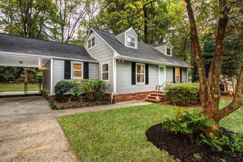 a view of a house with a backyard and a garden