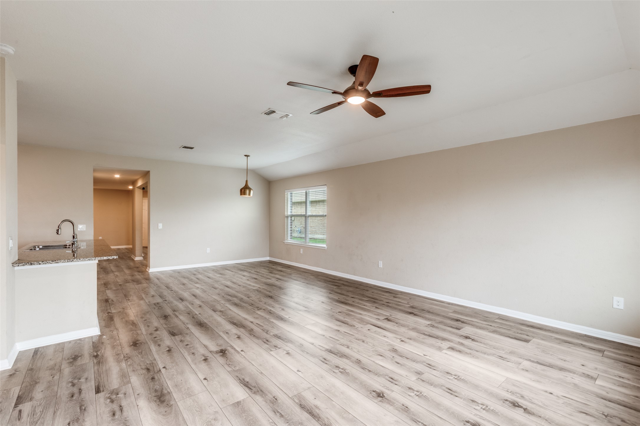 2909 Centrum Drive Austin, TX 78754 - Photo 13 of 30 Spacious room featuring light-toned flooring, a modern ceiling fan, and a window providing natural light