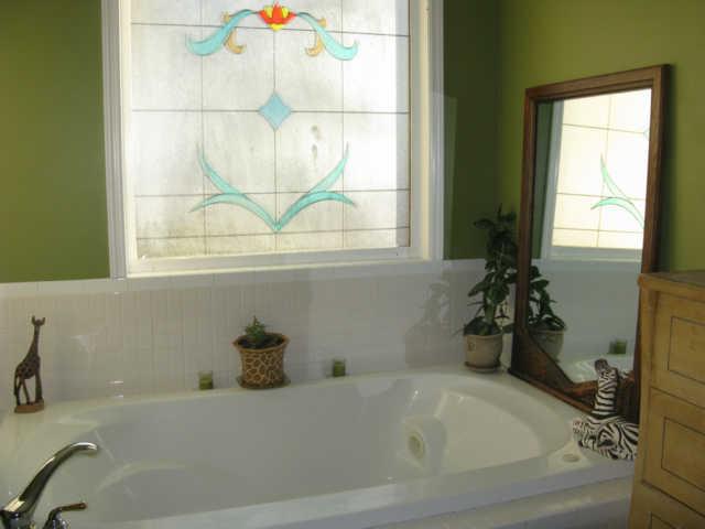 2656 Mcclure Cem Road Huntland, TN 37345 - Photo 8 of 20 Impressive master bath offers whirlpool tub enhanced by beautiful stain glass window.