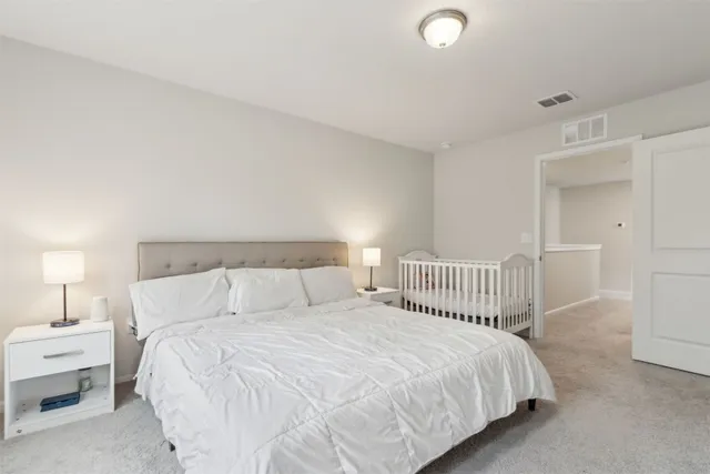 a bedroom with a bed and a lamp