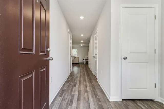 a view of hallway with wooden floor