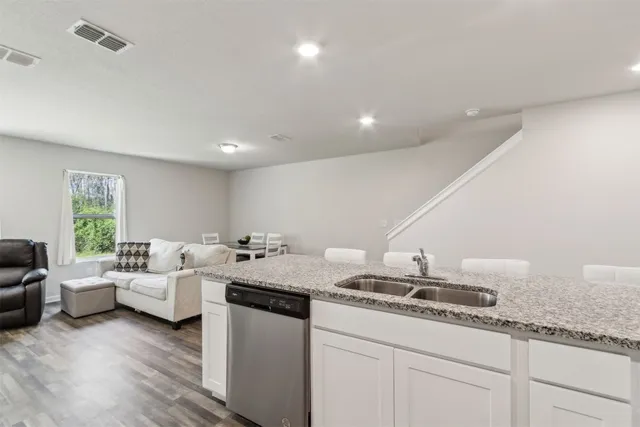 a living room with granite countertop furniture and fireplace