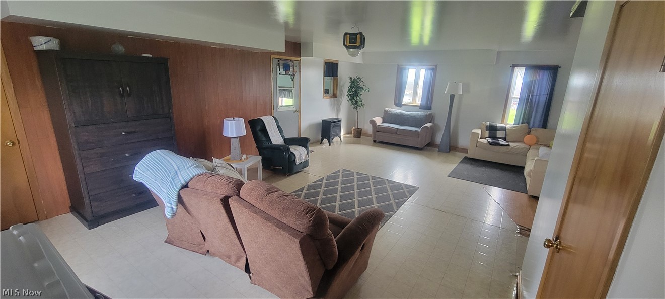 15560 Burton-Windsor Road Middlefield, OH 44062 - Photo 26 of 45 Living room with light tile flooring and wood walls