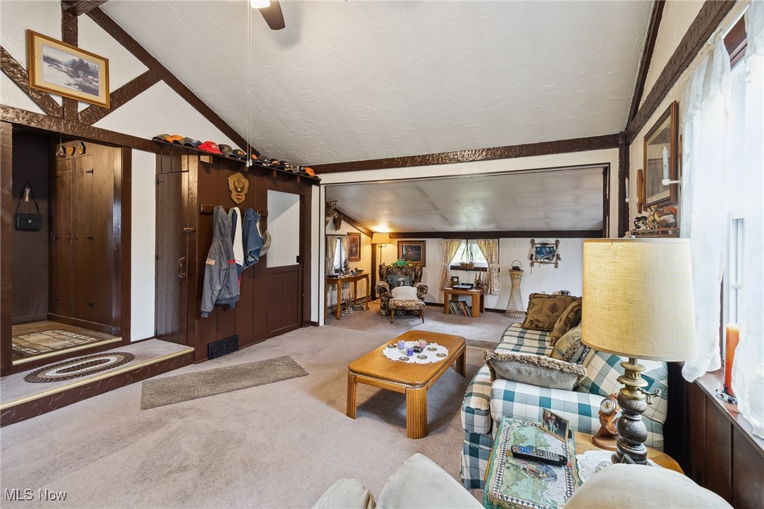 2860 Middle Road Pierpont, OH 44082 - Photo 9 of 50 Living room featuring carpet, lofted ceiling, and ceiling fan