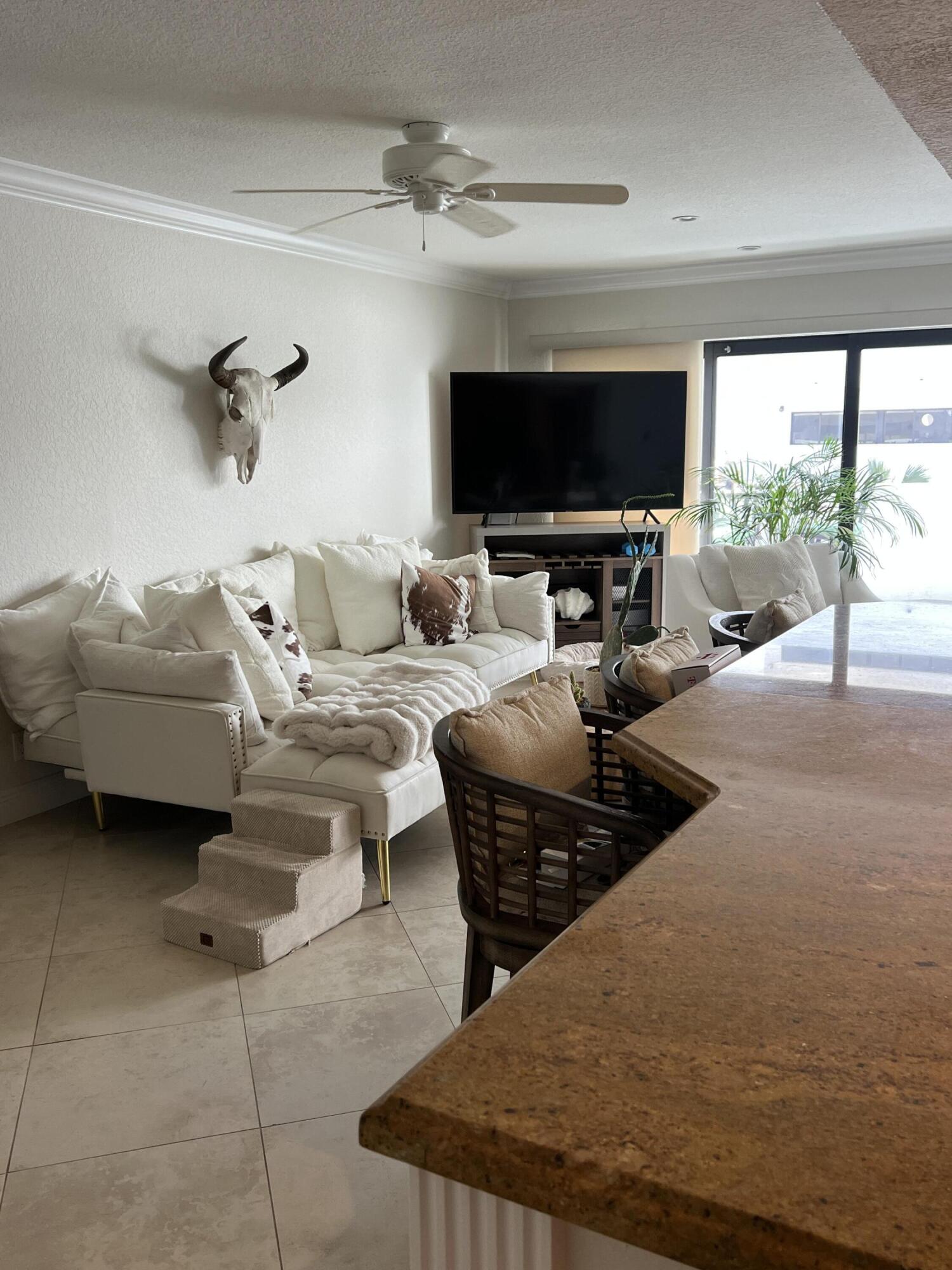 330 Southeast 20th Avenue, Unit 315 Deerfield Beach, FL 33441 - Photo 12 of 33 a living room with furniture and a flat screen tv