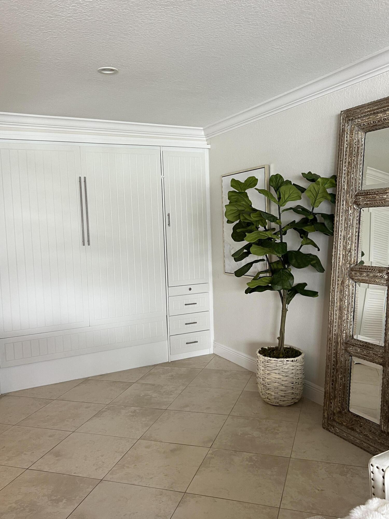 330 Southeast 20th Avenue, Unit 315 Deerfield Beach, FL 33441 - Photo 14 of 33 a vase of flowers sitting on a floor